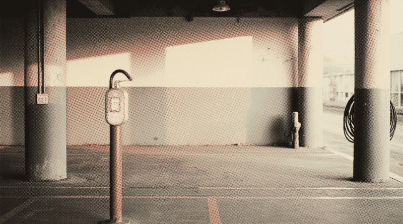 An empty covered parking bay at dawn — BYD vs Tesla Malaysia 2026: Price, Road Tax & Charging Cost (EV Guide)