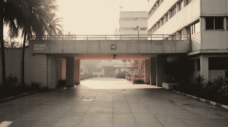 The forecourt of a hospital at dawn seen from across the driveway — Government vs Private Hospital Malaysia: Cost & Waiting Time