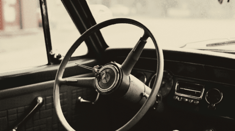 The steering wheel of an old parked car seen from the driver's seat in early morning — Renew Driving Licence Malaysia 2026: RM30/Year, MyJPJ Steps