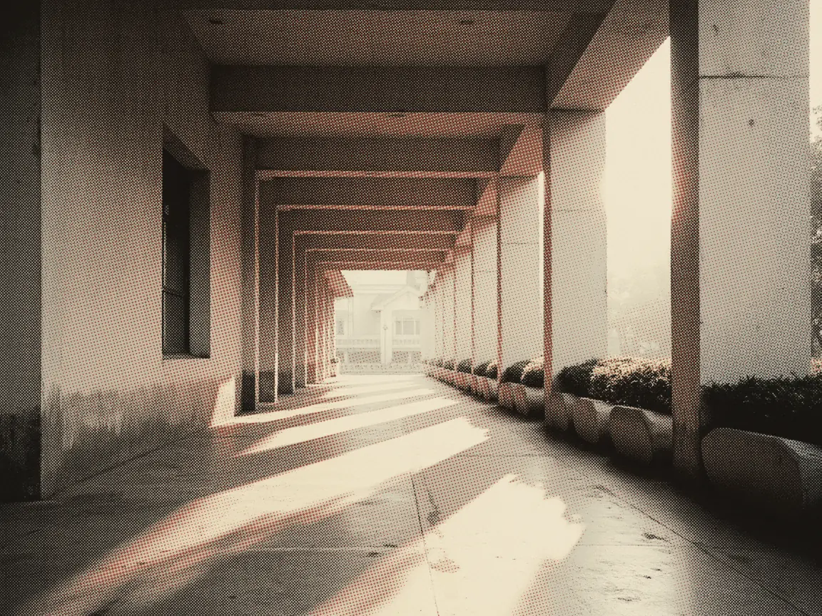 Change Name MyKad Malaysia 2026: JPN Fees & Forms — a sunlit covered walkway leading to a government building