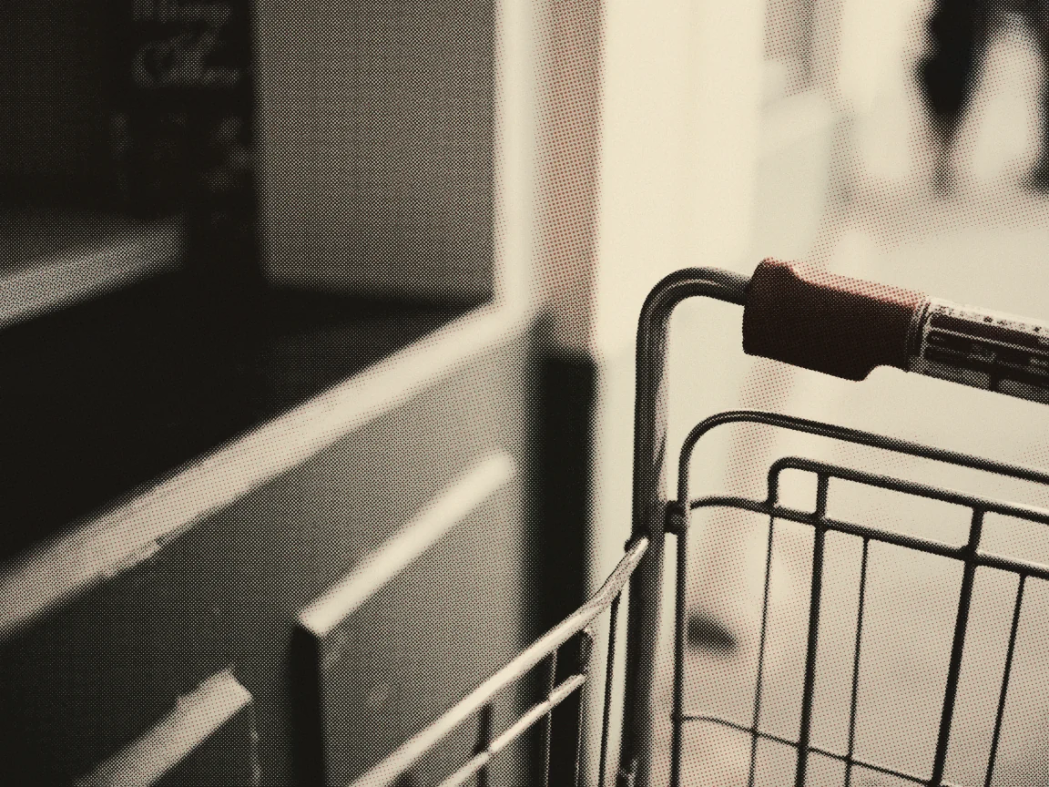 Cheapest Supermarket Malaysia 2026: Lotus’s vs Econsave vs AEON (Price War) — the handle of a shopping trolley with an empty wire basket