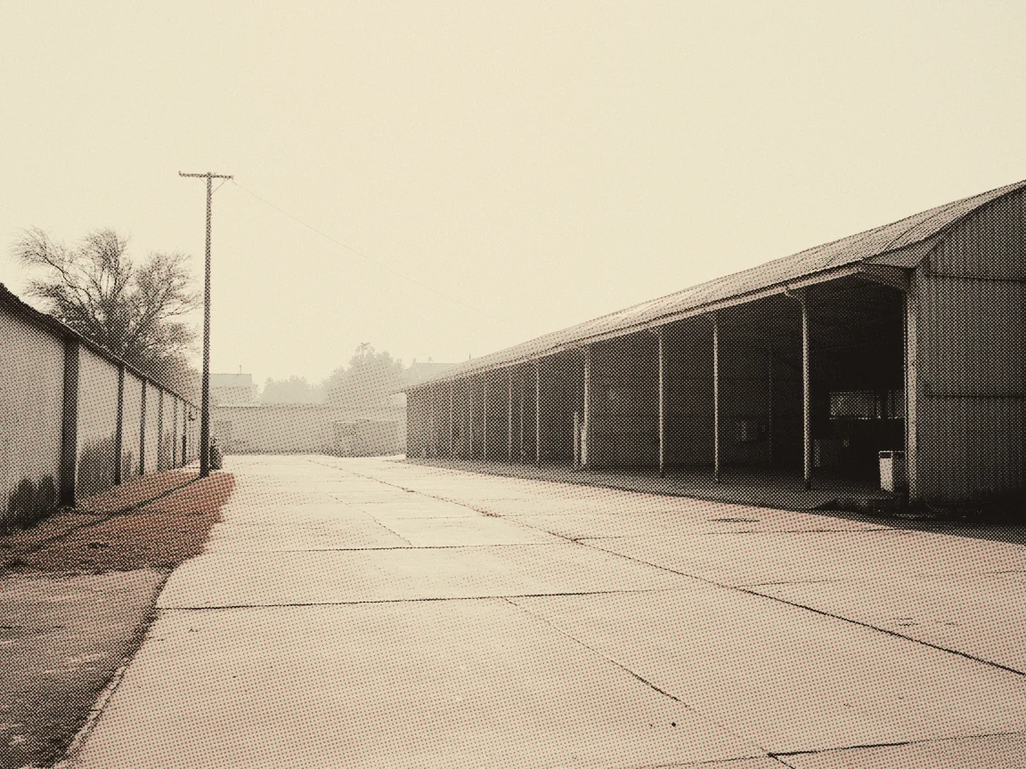 Employment Contract Malaysia 2026: The Legal Minimums — an empty road running past a long roadside warehouse in morning haze