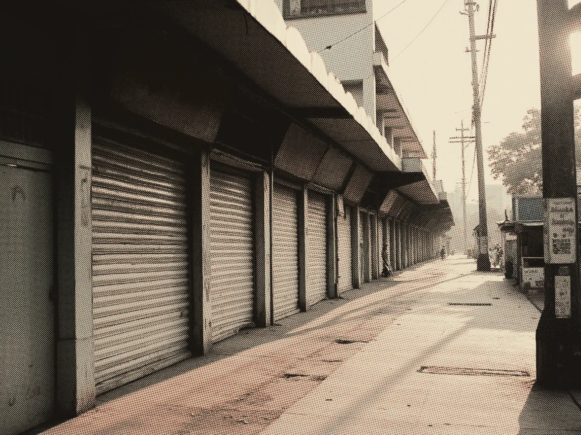SSM Registration Online 2026: Enterprise vs Sdn Bhd & Fees — a row of small shoplots with their shutters down at dawn