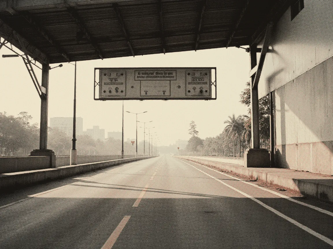 Touch 'n Go RFID 2026: Where to Install, Cost & Reload — an empty toll plaza lane with a gantry beam overhead