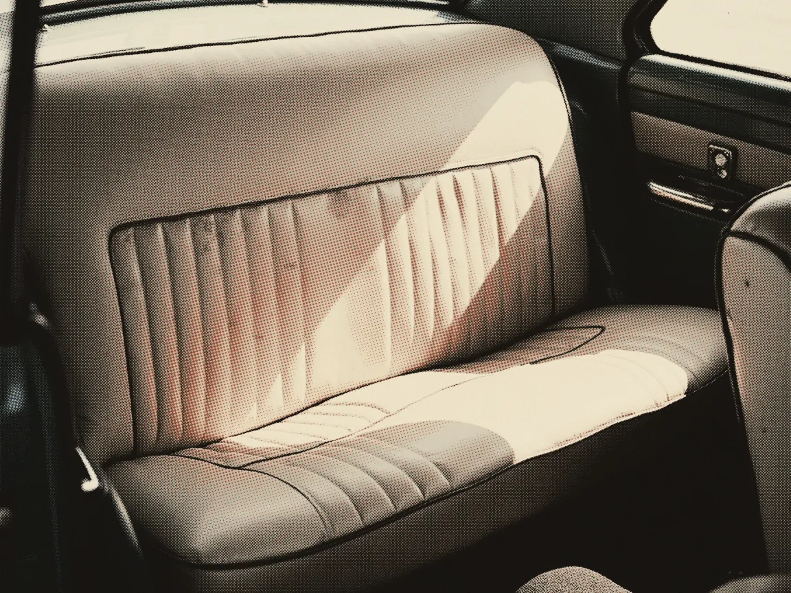 Car Ownership Transfer Malaysia 2026: JPJ and PUSPAKOM — the back seat of an older car, sunlight crossing the empty upholstery